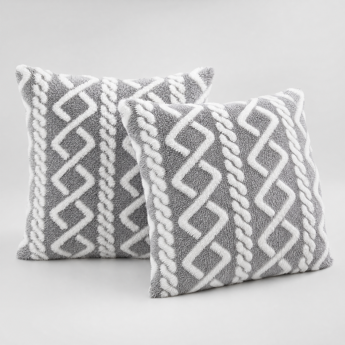 Grey and White cable knit plush cushion covers, set of 2, on a light grey background