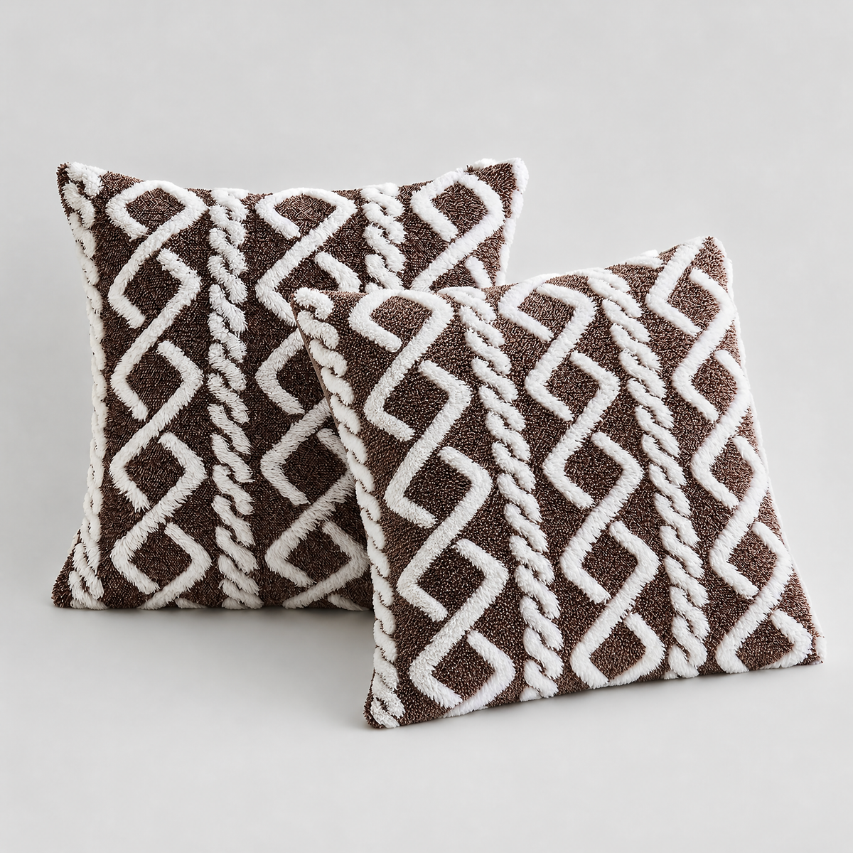 Brown and White cable knit plush cushion covers, set of 2, on a light grey background