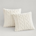 Cream cable knit plush cushion covers, set of 2, on a light grey background