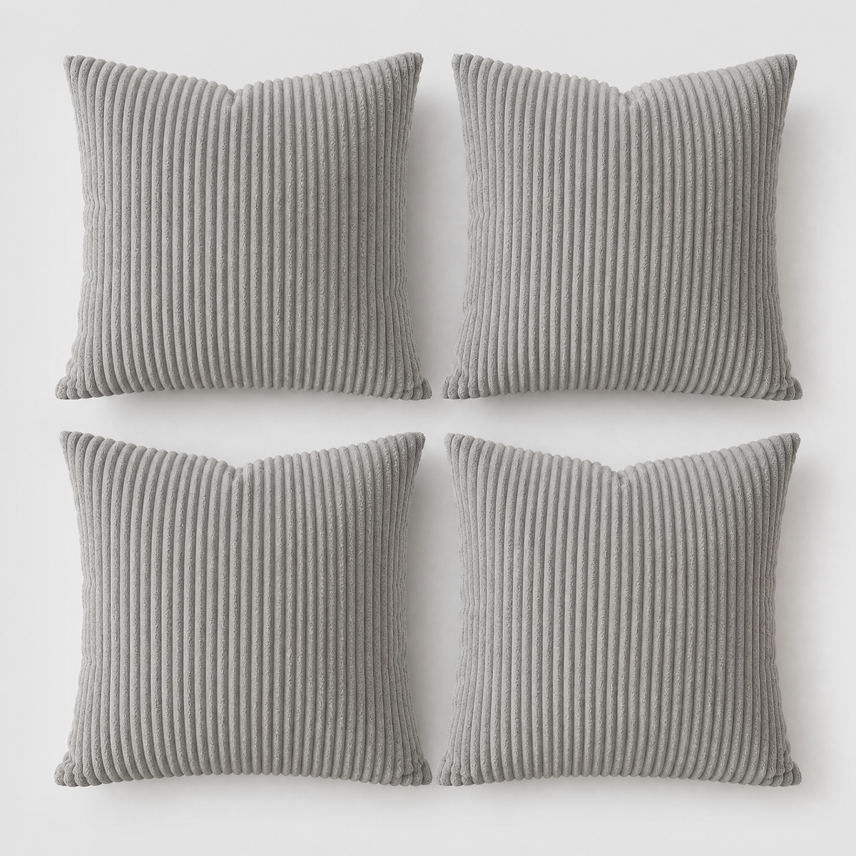 Grey set of four corduroy cushion covers on a light grey background
