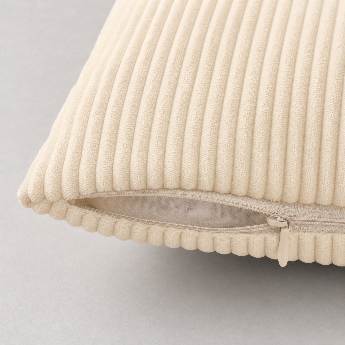 Hidden zipper along the bottom seam of a cream corduroy cover