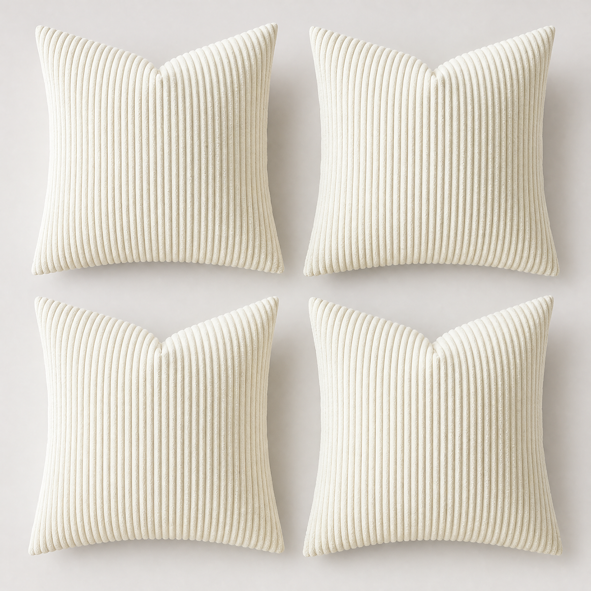 Cream set of four corduroy cushion covers on a light grey background