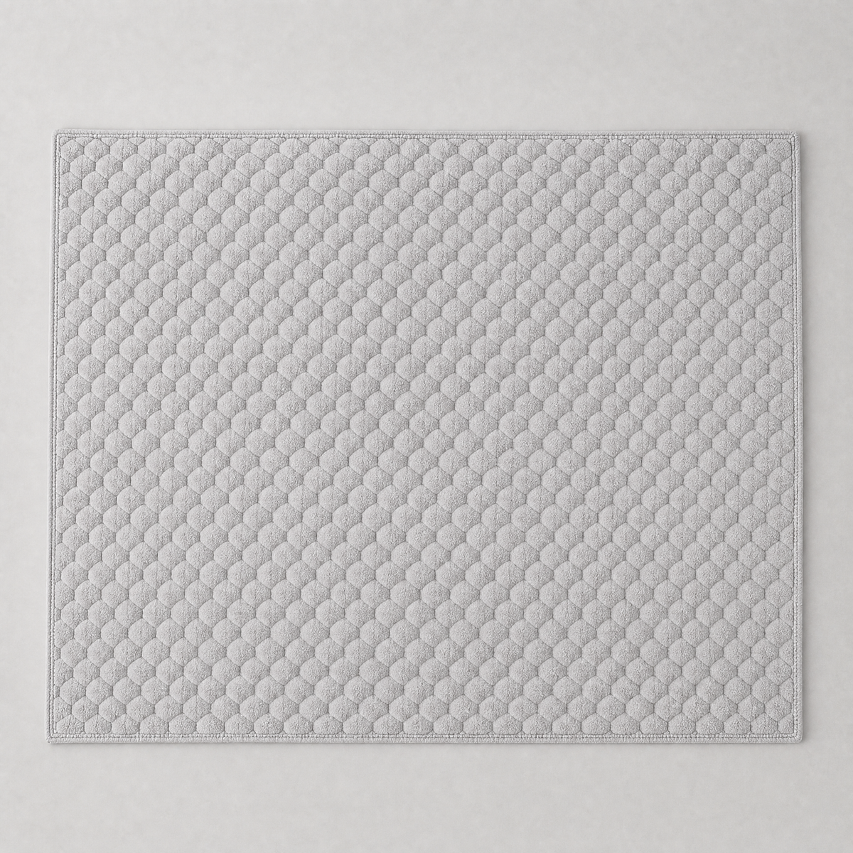 Grey honeycomb velvet couch cover laid flat, seen from above
