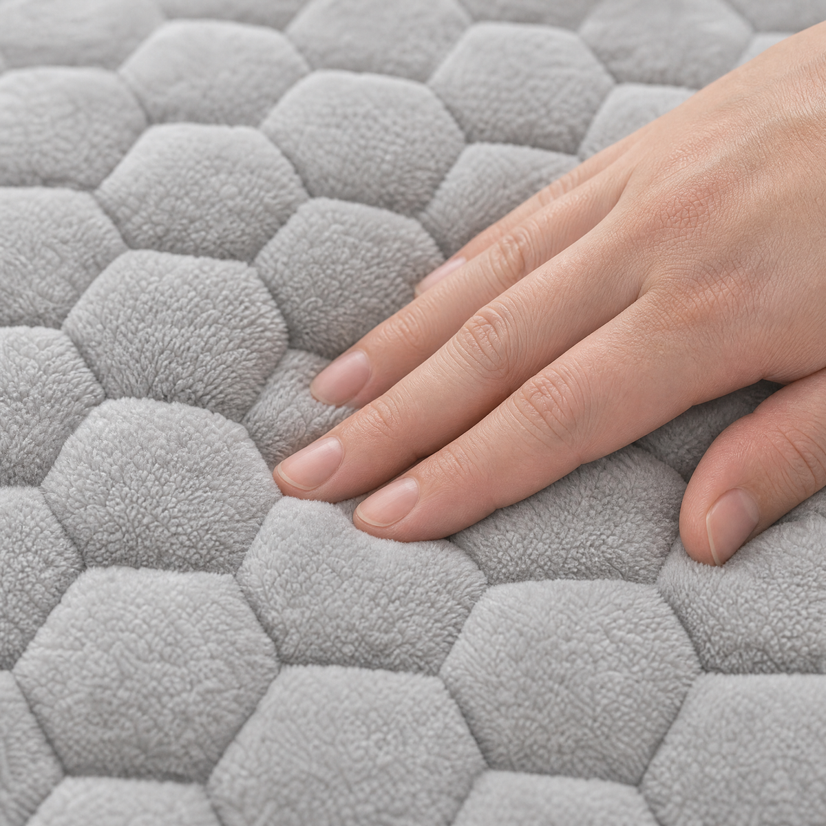 Hand pressing into the padded honeycomb quilting