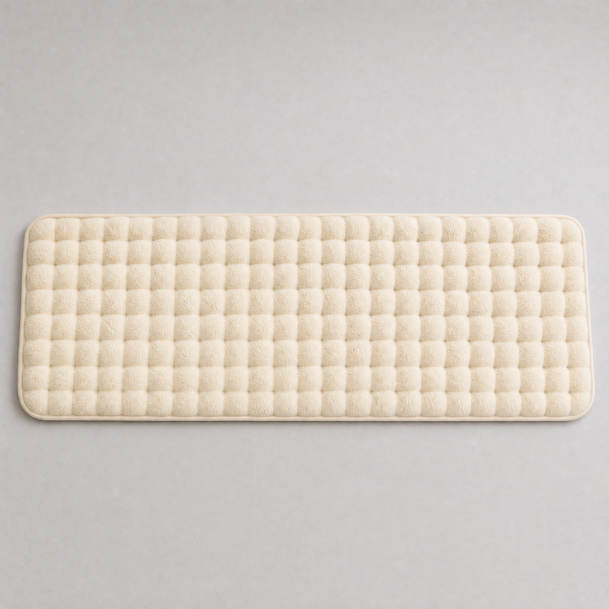 Ivory quilted faux fur couch cover laid flat, seen from above