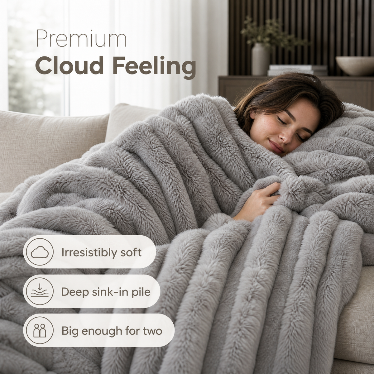 Grey rib plush blanket on a couch, woman resting under it