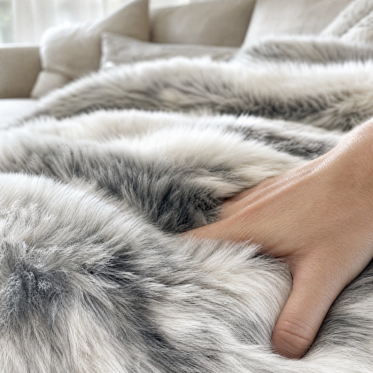 Close up of the marbled faux fur pile with a hand pressing into it