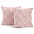 Two blush pink tufted diamond cushion covers on a white background