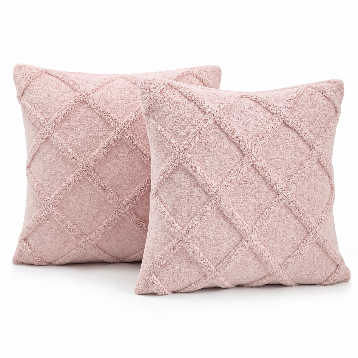 Two blush pink tufted diamond cushion covers on a white background