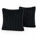 Two black ribbed plush cushion covers on a white background