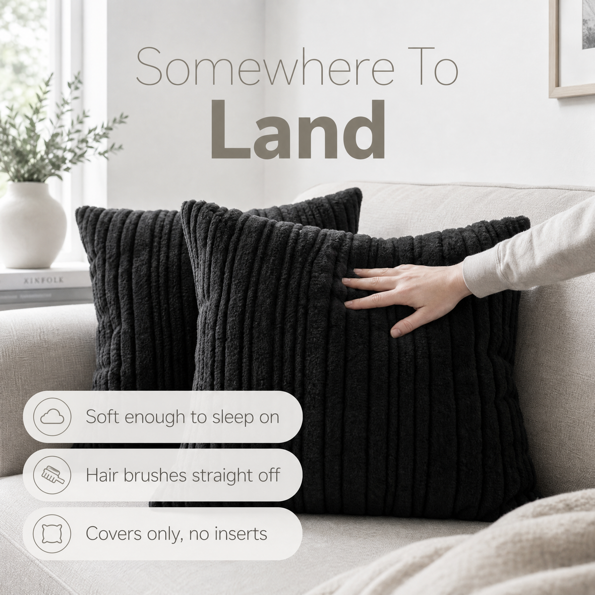 Black ribbed plush cushions on a linen sofa with a hand pressing into the pile