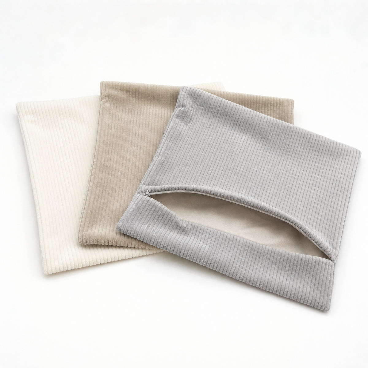 Three empty velvet corduroy cushion covers showing the open hidden zipper, inserts not included