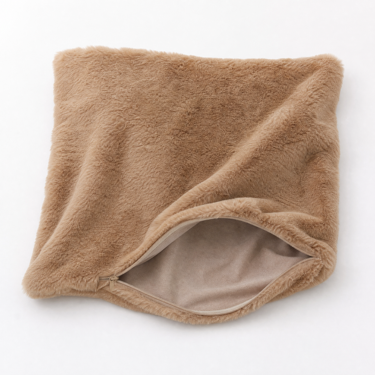 Empty camel faux fur cushion cover with the corner folded back to show the open zipper, insert not included