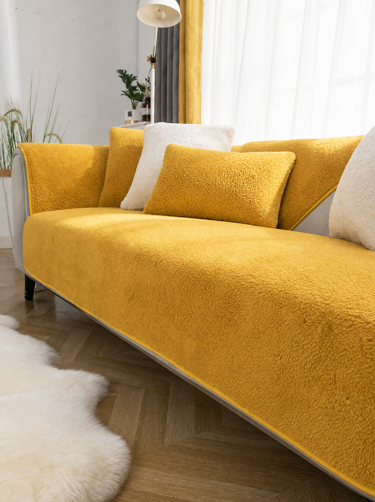 Yellow sherpa couch cover on a sofa in a bright living room