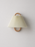 Beige pleated fabric wall sconce with a round wooden ring mount