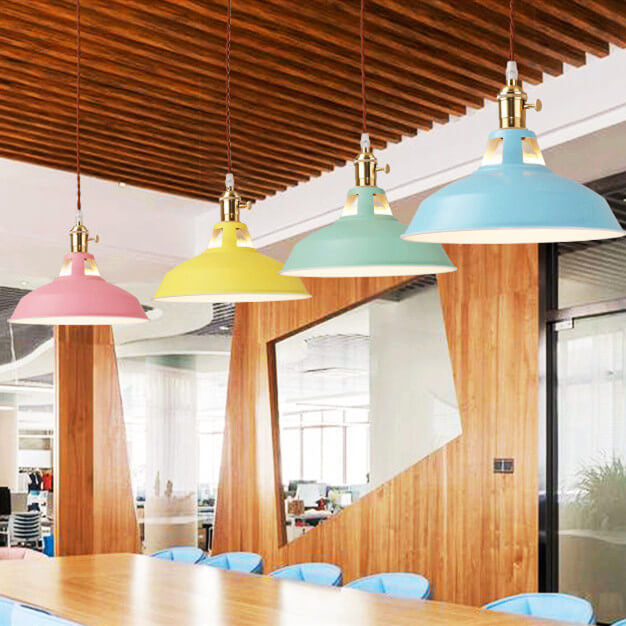 Barn pendant lights in four colors over a long table