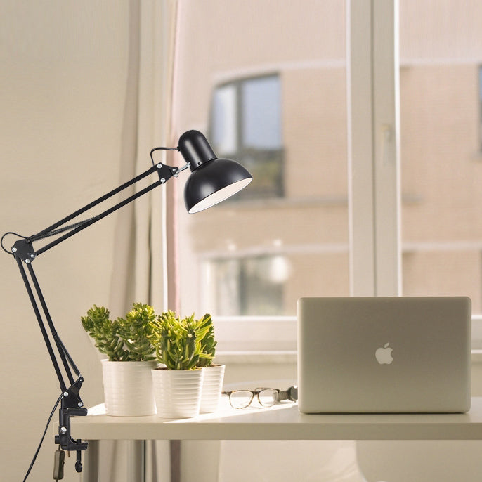 Clip on lamp with long arm clamped to a bed