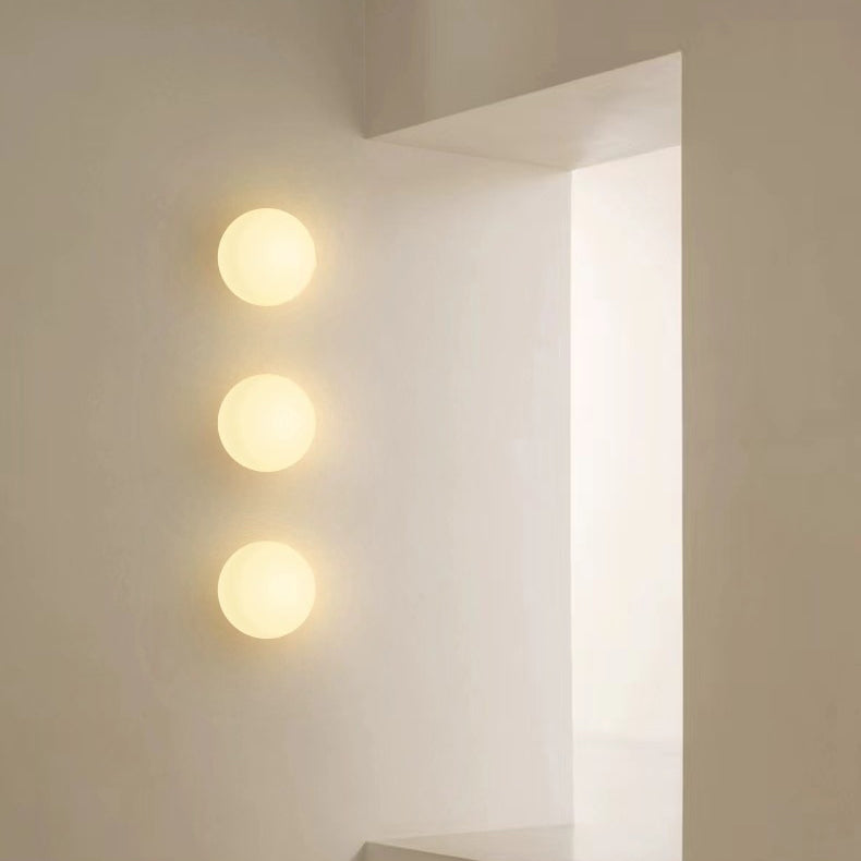 Small frosted glass orb wall sconce