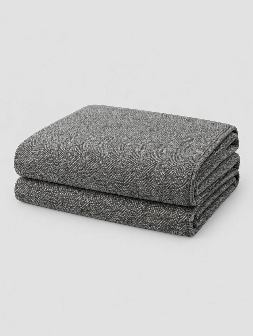 Chenille Couch Cover in grey, folded on a light grey background