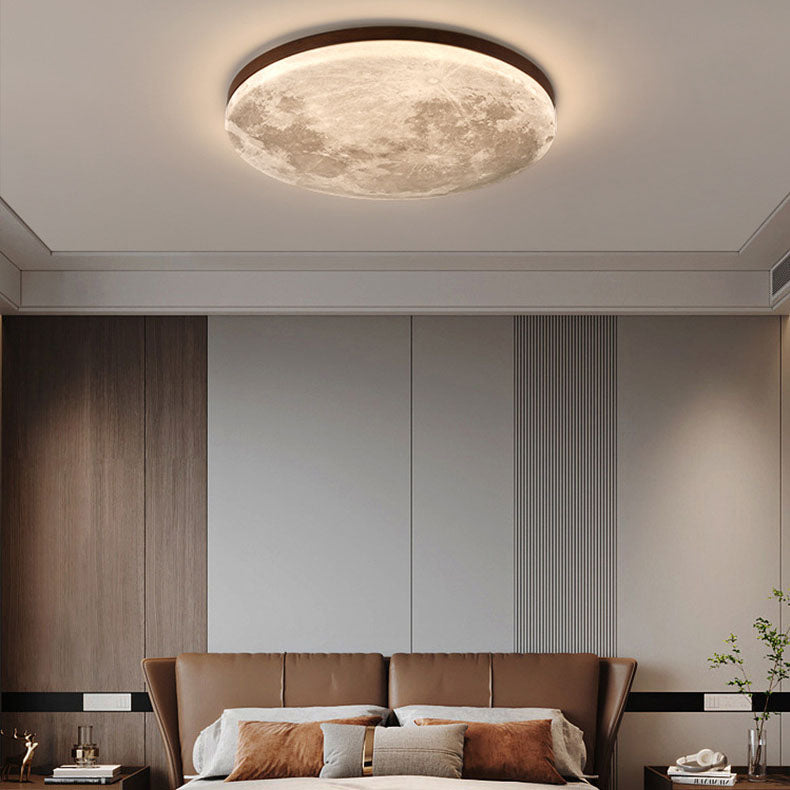 Moon ceiling light in walnut above a bed