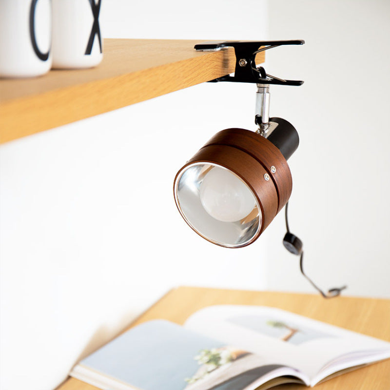 Round wood clip lamp on a bookshelf