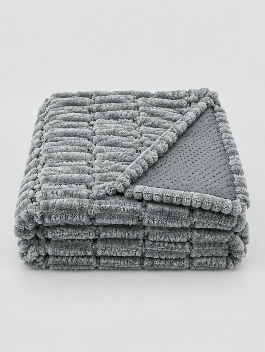 Flannel Couch Cover in grey, folded on a light grey background