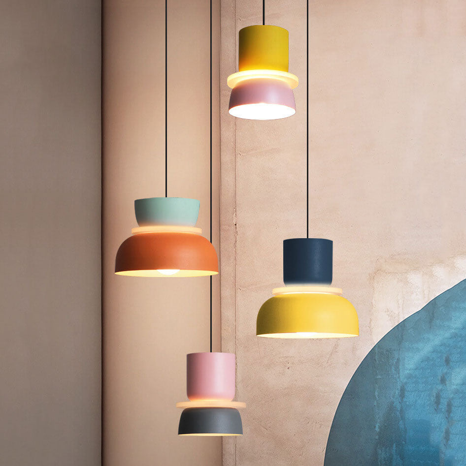 Two tone pastel pendant lights over a dining table